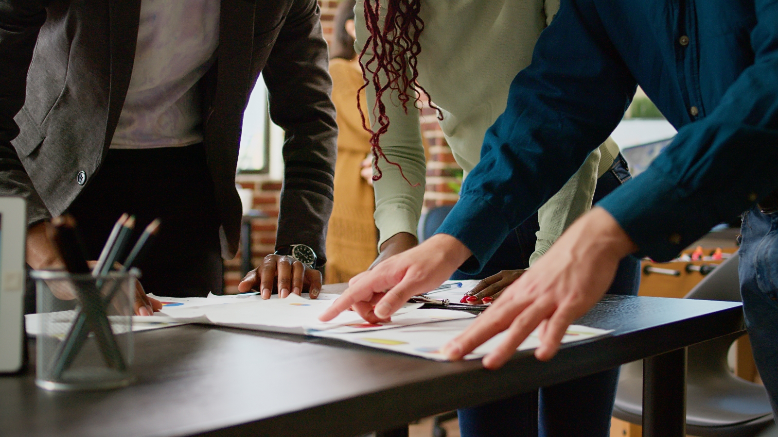 diverse team coworkers looking business charts documents analyzing research information statistics diagrams review people using papers with infographics data report close up